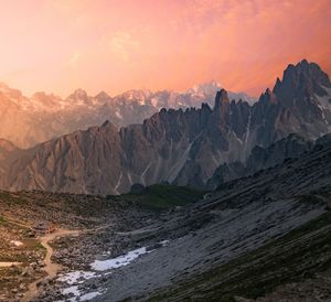 Scenic view of snowcapped mountains against sky during sunset