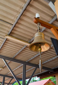 Low angle view of electric lamp hanging on ceiling