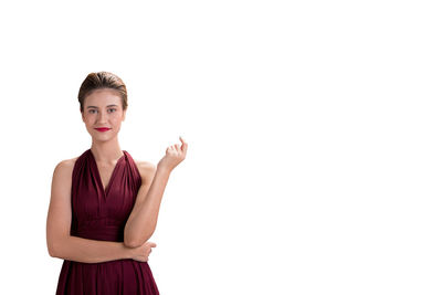 Portrait of young woman against white background