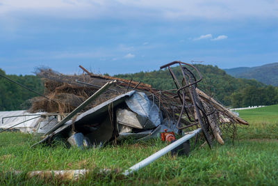 Abandoned truck on field against sky
