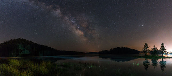 Scenic view of lake against star field at night