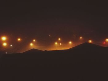 Illuminated mountain against sky at night