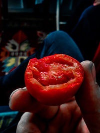 Close-up of hand holding strawberry