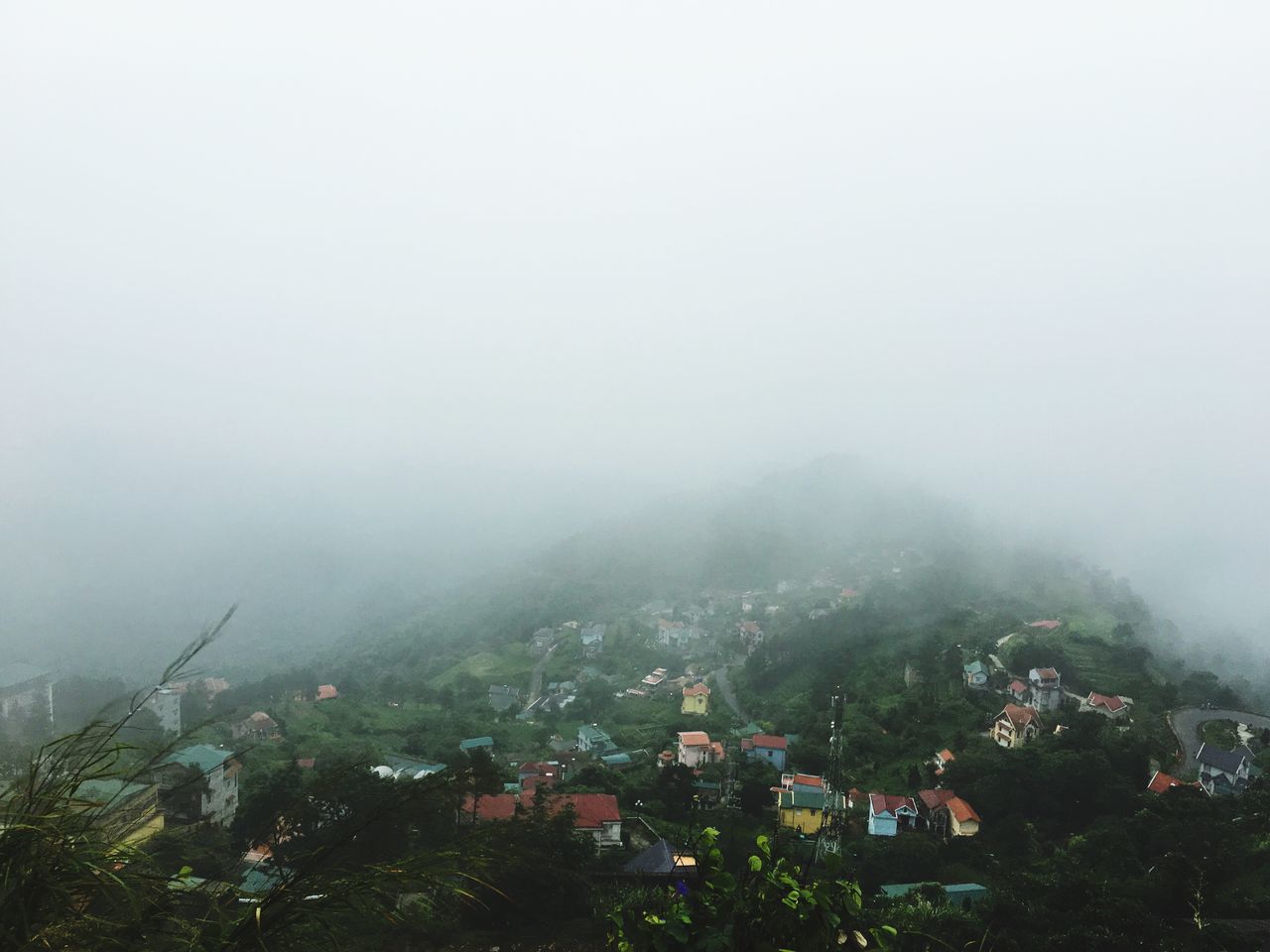 architecture, fog, built structure, foggy, weather, tree, residential structure, residential district, mountain, residential building, sky, townscape, city, town, nature, day, landscape, cityscape, overcast, outdoors, no people, beauty in nature, scenics, tranquility, tranquil scene, growth, elevated view