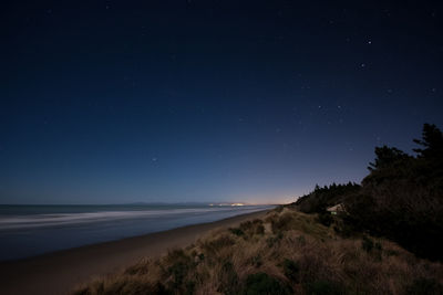 Scenic view of sea against sky at night