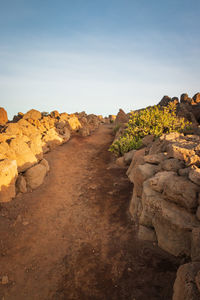 Rock formations on landscape against sky