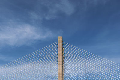 Low angle view of bridge against cloudy sky