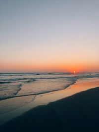 Scenic view of sea against clear sky during sunset