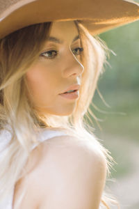 Close-up of woman wearing hat looking away