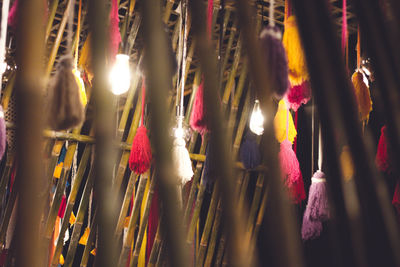 Close-up of illuminated lanterns hanging in row