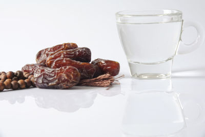 Close-up of breakfast on table against white background