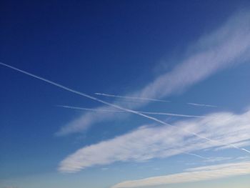 Low angle view of vapor trails in sky