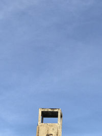 Low angle view of old building against blue sky