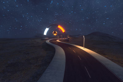 Light trails on road against sky at night