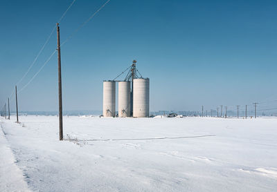 Built structure on snow covered land against sky