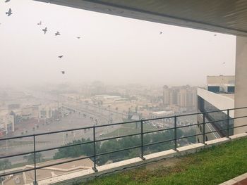 High angle view of buildings seen through window