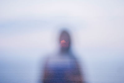 Woman in sea against clear sky