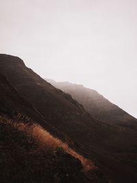 Scenic view of mountains against sky during foggy weather