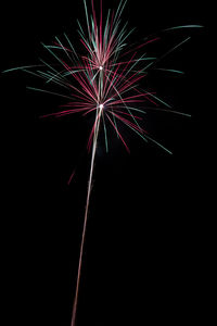 Low angle view of firework display at night