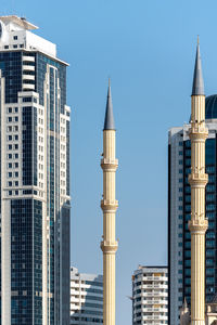 Low angle view of skyscrapers against clear sky