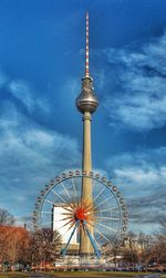 Low angle view of ferris wheel against sky