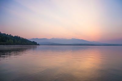 Scenic view of lake against sky during sunset