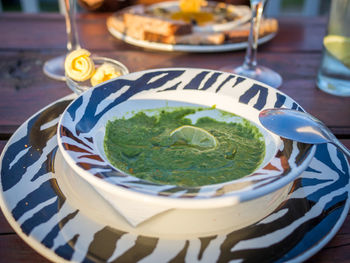 Close-up of spinach soup in plate on table