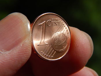 Close-up of hand holding coins