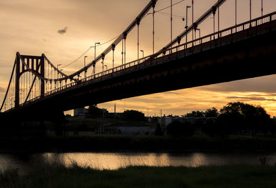 Bridge over river during sunset