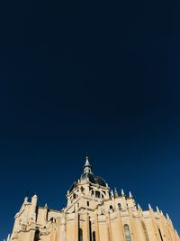 Low angle view of building against clear blue sky