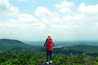 Rear view of man standing against sky