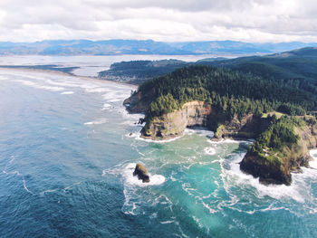 Scenic view of sea and mountains against sky