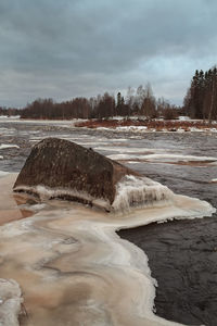 Scenic view of frozen lake against sky