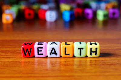 Close-up of text on multi colored toy blocks table