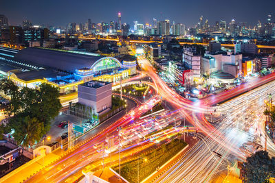 High angle view of illuminated city street and buildings at night