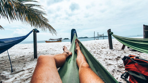 Low section of people relaxing on beach