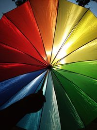 Low angle view of multi colored umbrella against sky