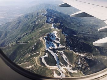 Aerial view of airplane wing over landscape