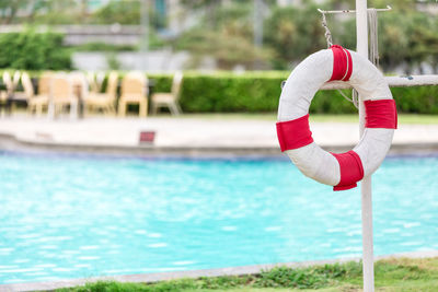 Woman with umbrella on swimming pool