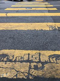 High angle view of yellow crossing sign on road