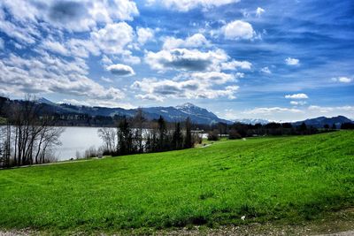 Scenic view of landscape against cloudy sky