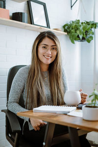 Mexican young woman works with natural pose in her home office