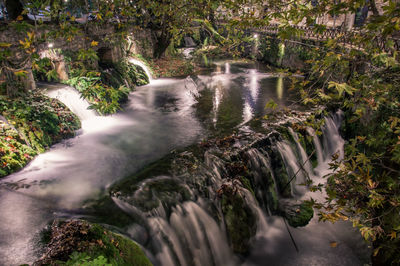 Stream flowing through rocks in forest