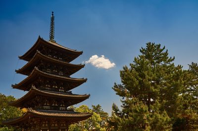 Low angle view of kofuku-ji pagoda by trees against sky