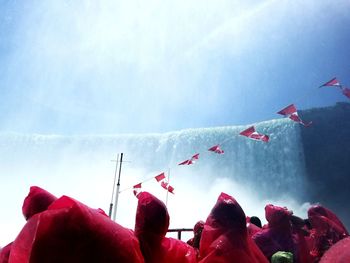 People standing against waterfall