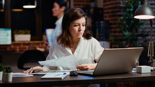 Businesswoman using laptop at office