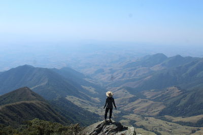 Rear view of man walking on mountain