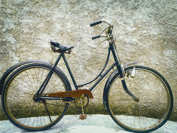 Bicycle parked against wall