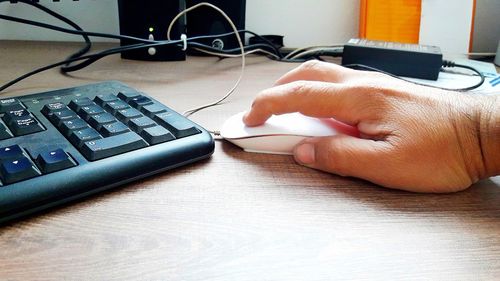 Midsection of person using smart phone on table