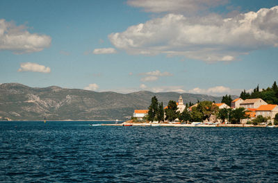 Scenic view of sea against sky in city